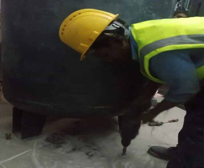 Technician installing an air receiver tank