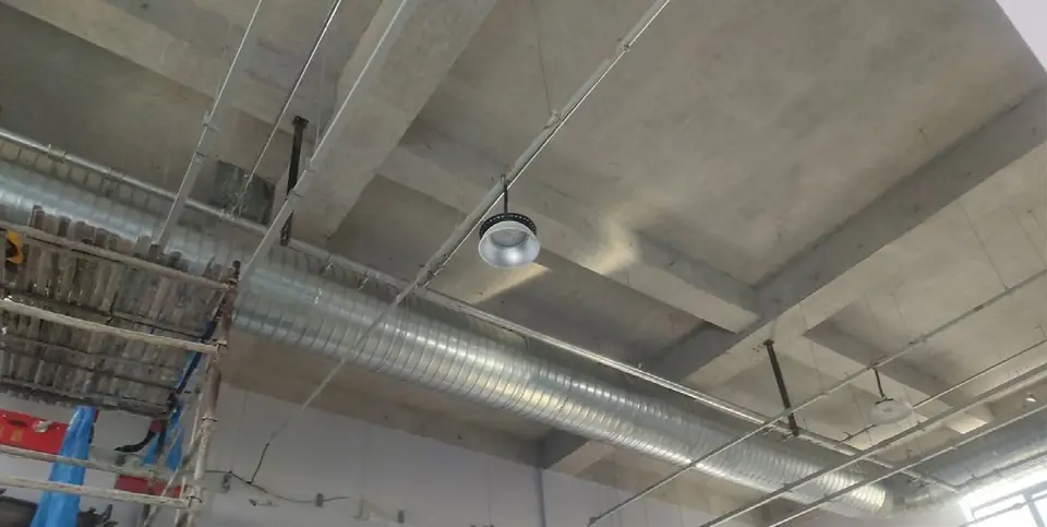 Compressed air lines running along a factory ceiling