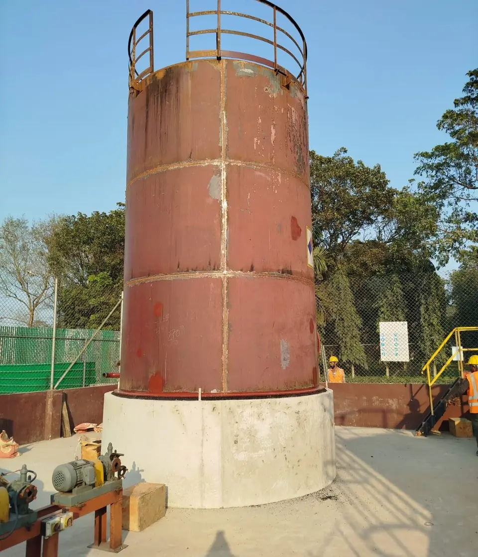 Storage tank set on its new ring wall foundation at a factory site