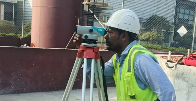 Surveyor checking levels on the finished foundation