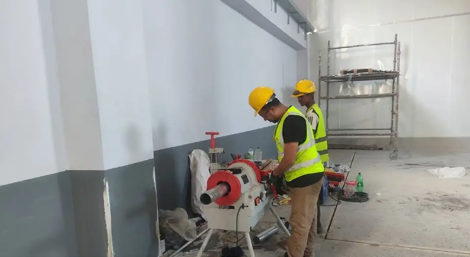 Pipe threading machine preparing GI service lines